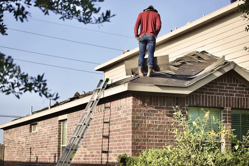 Professional roofer working on a residential roof in Centreville